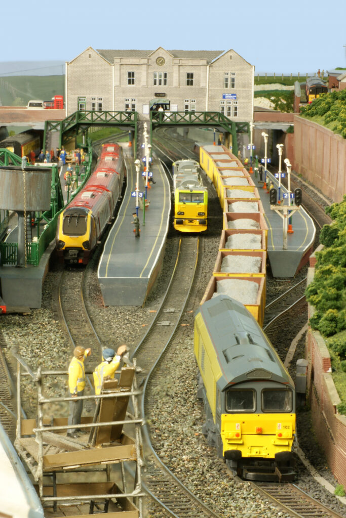 Image of Forleigh Station platforms with multiple trains in the platforms taken looking along the track.