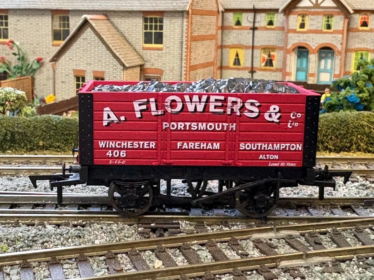 Side view of the red A. Flowers & Co. Portsmouth OO gauge coal wagon