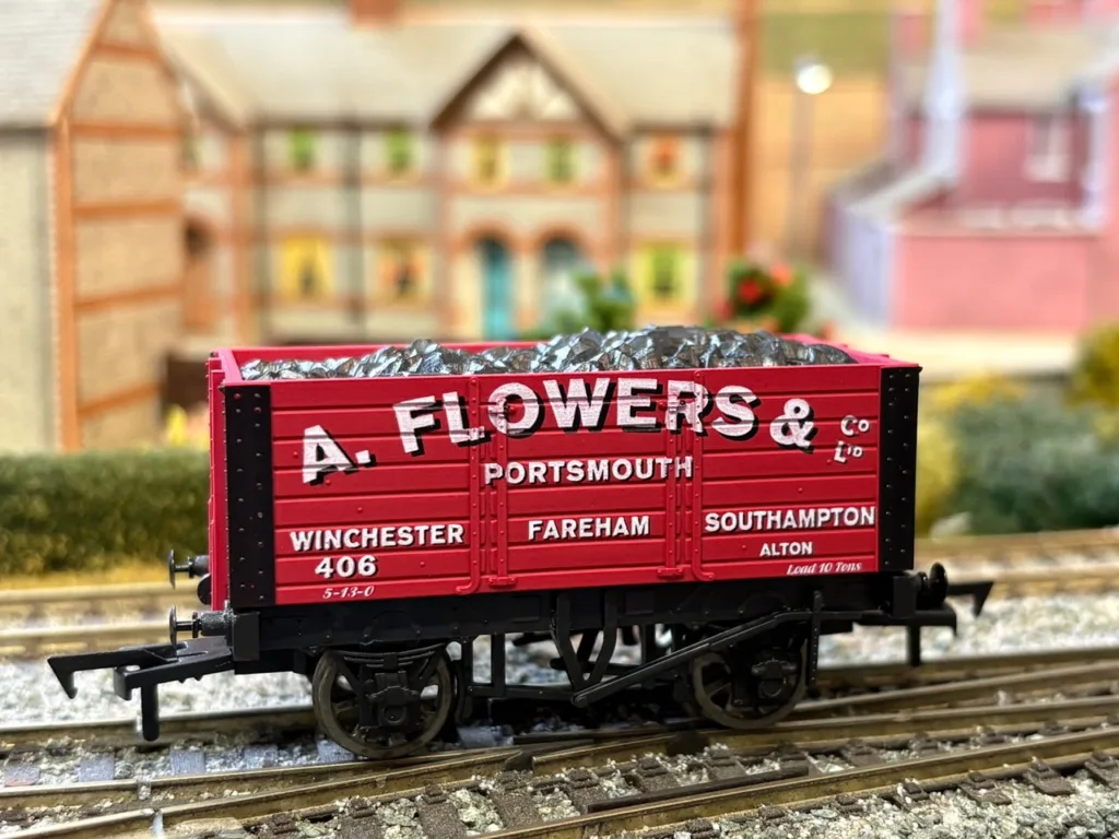 Red A. Flowers & Co. Portsmouth OO gauge coal wagon on a model railway layout